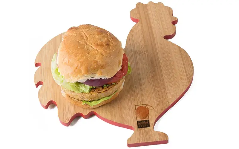 GariMark Foods chicken burger on a rooster-shaped cutting board